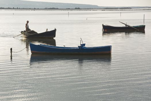 Sunset in the lagoon, where fishermen return to the approach of the impending storm. Dawning. Mediterranean islands.