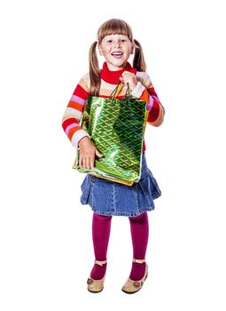 Smiling six years Girl holding presents bags isolated