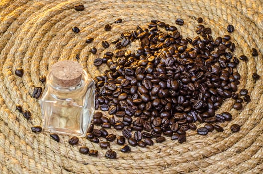 Glass jar with coffee beans on a jute rope.