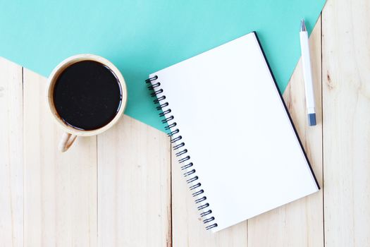 Still life, business, office supplies or education concept : Top view image of open notebook with blank pages and coffee cup on wooden background, ready for adding or mock up