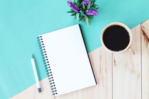 Still life, business, office supplies or education concept : Top view image of open notebook with blank pages and coffee cup on wooden background, ready for adding or mock up