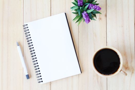 Still life, business, office supplies or education concept : Top view image of open notebook with blank pages and coffee cup on wooden background, ready for adding or mock up