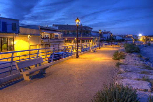 Promenade near mediterranean sea by night, Saintes-Maries-de-la-mer, Camargue, France, HDR