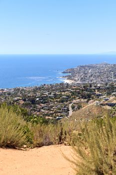 High hillside view of coastline of Laguna Beach with the ocean in Summer.