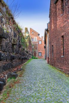 Small alley with city wall of the city of Zons, Germany.