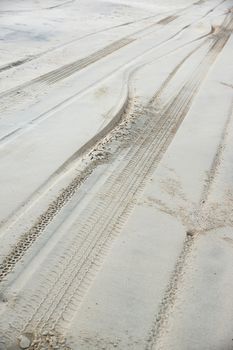 traces of tires traveling through the sand