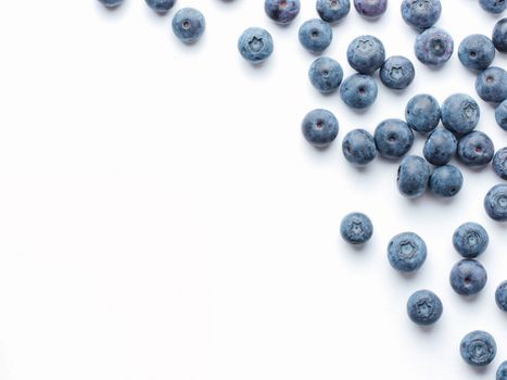 Blueberries isolated on white background. Blueberry border design. Ripe and juicy fresh picked bilberries close up. Copyspace. Top view or flat lay