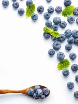 Blueberries isolated on white background. Blueberry border design. Ripe and juicy fresh picked bilberries close up. Copyspace. Top view or flat lay