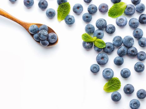 Blueberries isolated on white background. Blueberry border design. Ripe and juicy fresh picked bilberries close up. Copyspace. Top view or flat lay