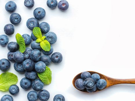 Blueberries isolated on white background. Blueberry border design. Ripe and juicy fresh picked bilberries close up. Copyspace. Top view or flat lay