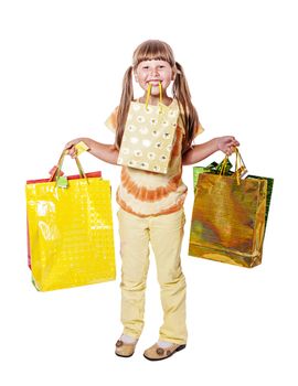 Smiling six years Girl holding presents bags isolated