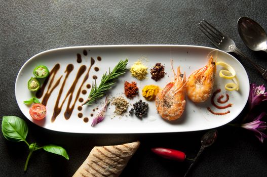 Fresh food platter with fresh herbs and spices and cooked prawns 