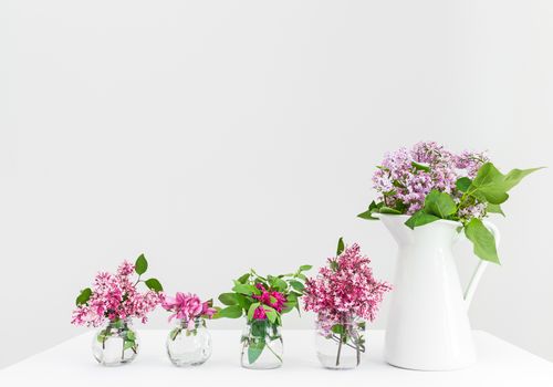 Vases with pink and purple spring flowers. Beautiful floral arrangement.