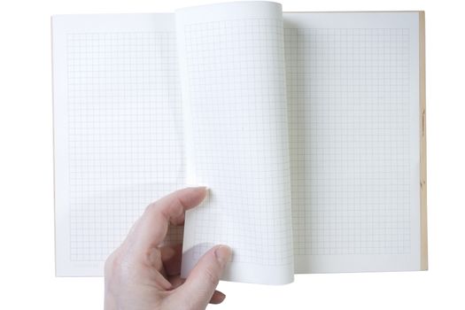 Hand turns the notebook page on white background