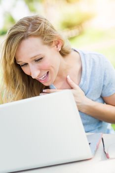 Young Adult Woman Live Video Chatting Outdoors Using Her Laptop.