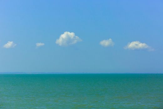 Nature background, clear water and blue cloudy sky.