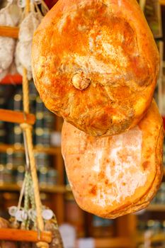 Jamon serrano hung at the entrance of a gourmet shop