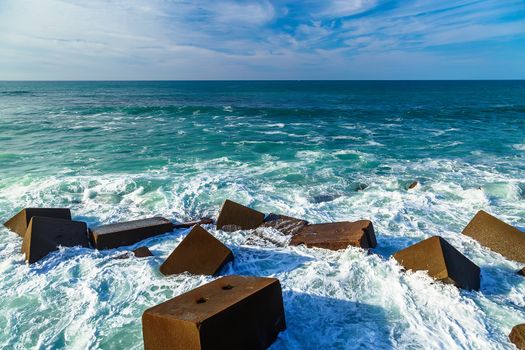 Seascape with rocks, foam and spray of the waves