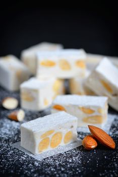 White nougat with almonds on black ardesia plate