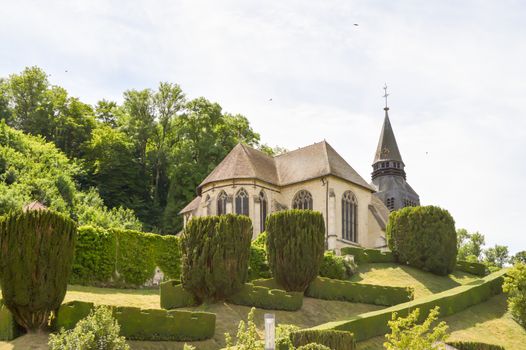 Small church on a hill with trees carved in the department of the Meuse in France