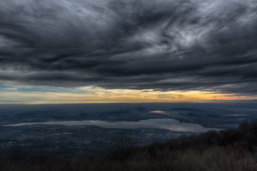 Dramatic sky at the sunset over the Varese lake, rainy season - Lombardy, italy