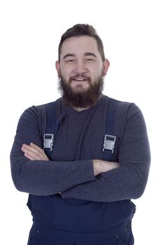 Portrait of happy handyman in overalls standing arms crossed over white backgound