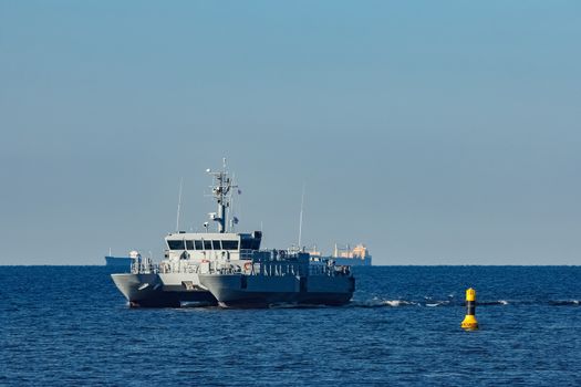 Small grey military ship moving from Baltic sea