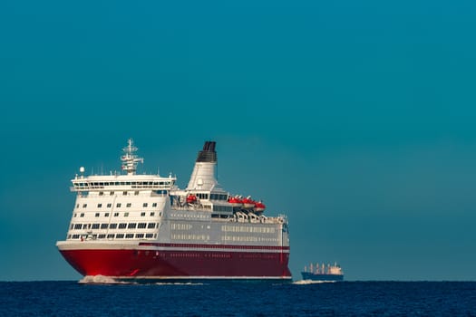 Red cruise liner. Large passenger ferry underway