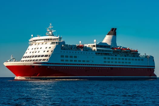 Red cruise liner. Large passenger ferry underway