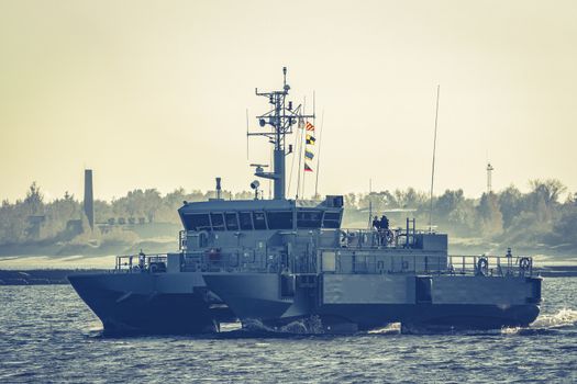 Small grey military ship moving from Baltic sea
