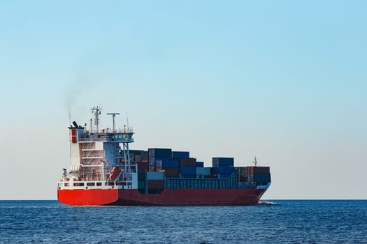 Red container ship sailing to the Baltic sea
