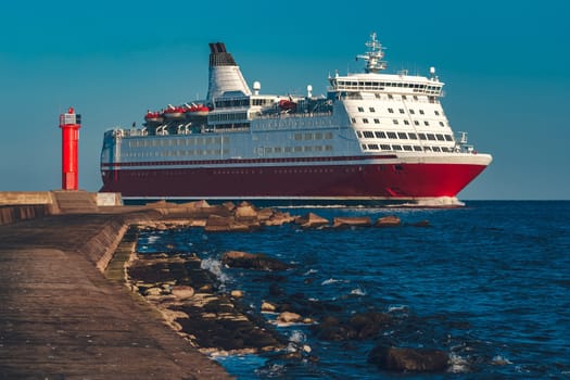 Red cruise liner. Large passenger ferry underway