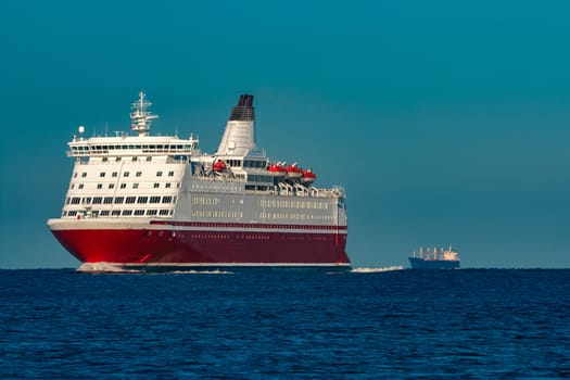 Red cruise liner. Large passenger ferry underway