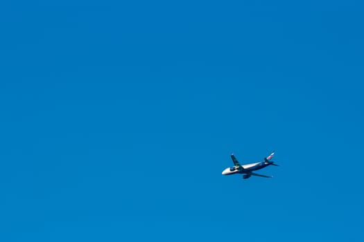Passenger aircraft flying in the blue sky