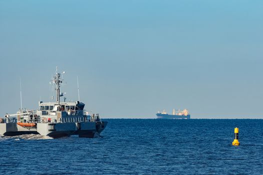 Small grey military ship moving from Baltic sea
