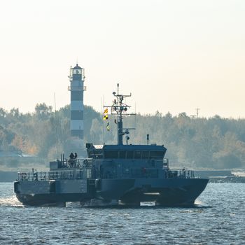 Small grey military ship moving from Baltic sea