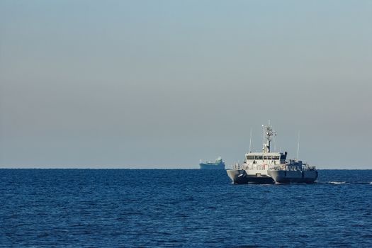 Small grey military ship moving from Baltic sea