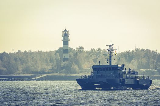 Small grey military ship moving from Baltic sea