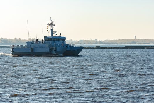 Small grey military ship moving from Baltic sea