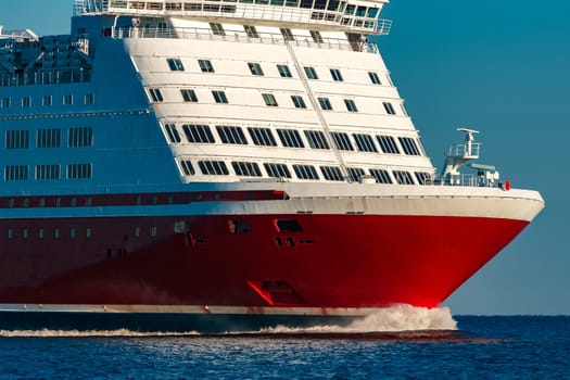 Red cruise liner. Large passenger ferry underway