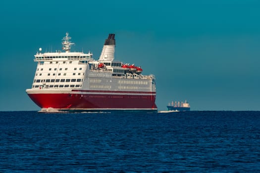 Red cruise liner. Large passenger ferry underway