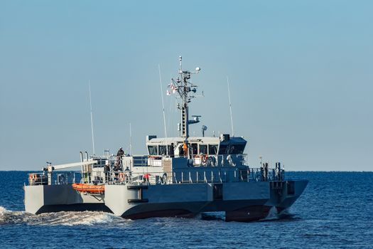 Small grey military ship moving from Baltic sea