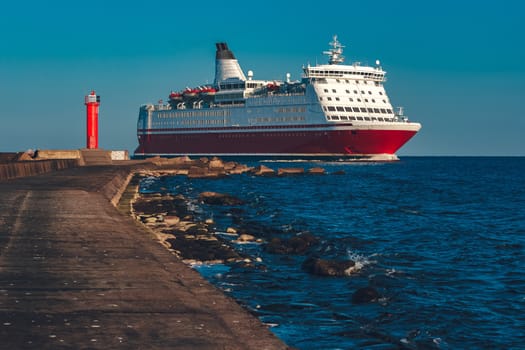 Red cruise liner. Large passenger ferry underway