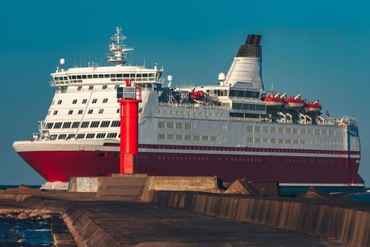 Red cruise liner. Large passenger ferry underway