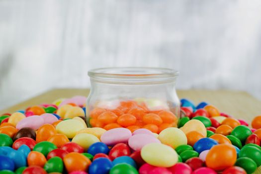 Tasty Sweets in jar on the silver background.