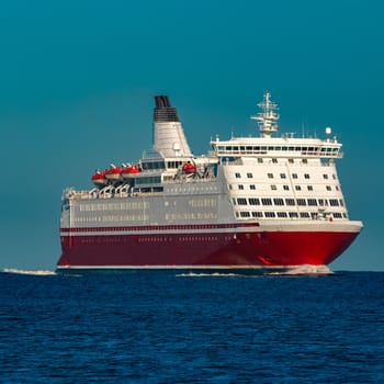 Red cruise liner. Large passenger ferry underway