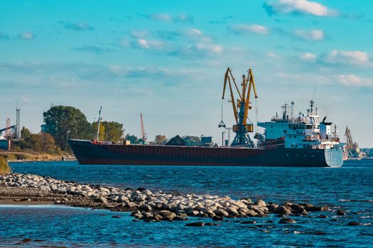Blue cargo ship moving to the cargo port