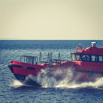 Red pilot ship moving from the Baltic sea