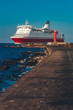 Red cruise liner. Large passenger ferry underway