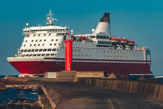 Red cruise liner. Large passenger ferry underway